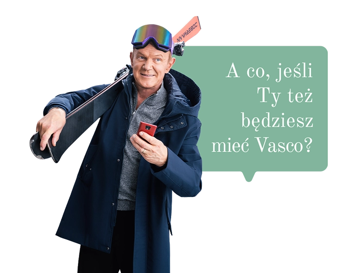 Cezary Pazura w świątecznym swetrze trzyma prezent i otwiera go, a w środku widać pudełko Vasco Translatora. W tle dymek z tekstem: A co jeśli podarujesz komuś Vasco?